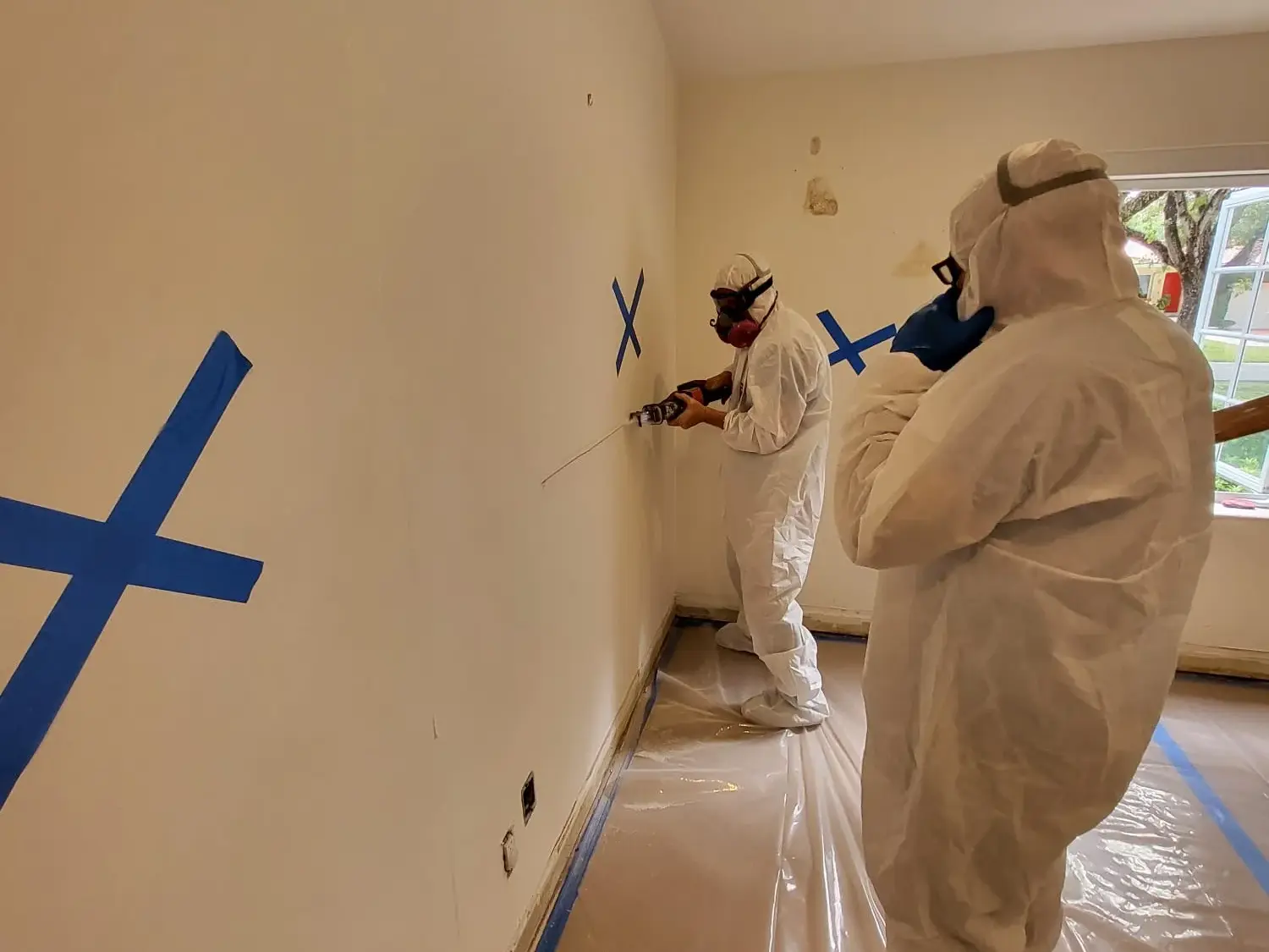 Mold remediation crew removing affected materials during demolition